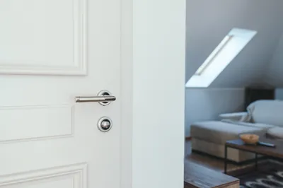 Hotel apartment door, white wooden doorway with metal handle